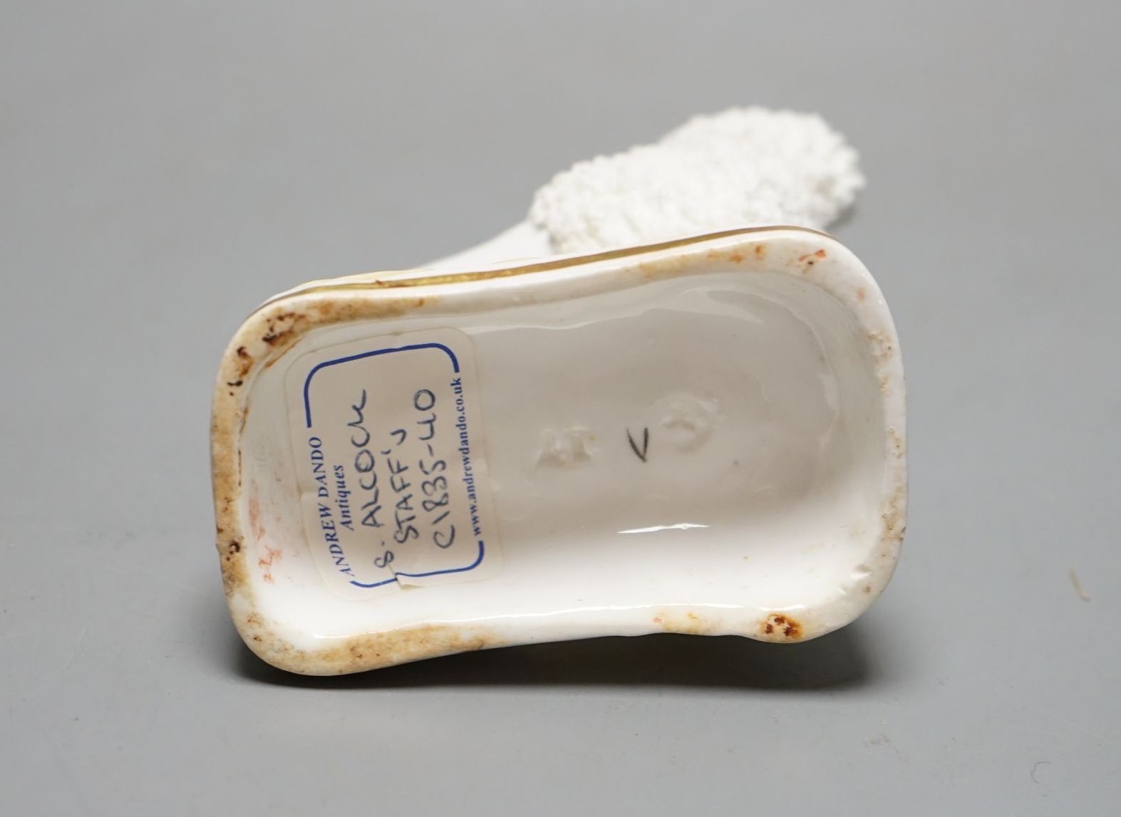 A rare Samuel Alcock porcelain figure of a standing poodle holding a hat in its mouth, c.1835-50, impressed ‘17’, Provenance: Dennis G. Rice collection, apparently an unrecorded model when Dr Rice published his book., 8.